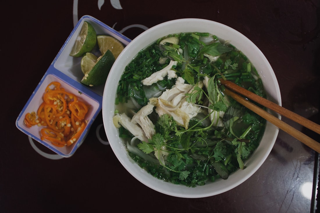 A generous spread of fresh Vietnamese herbs, banana blossom, and lime — the soul of the side plate